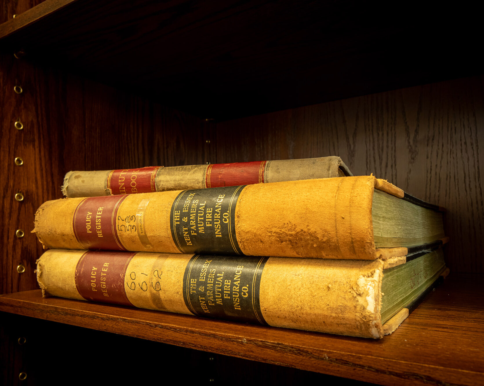 Three really old books stacked on top of each other