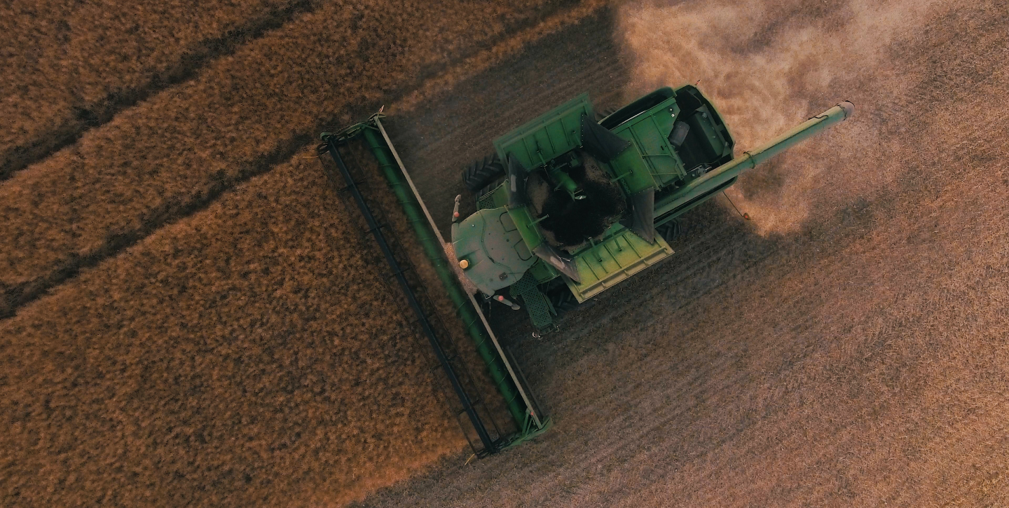 Tractor harvesting crops in field