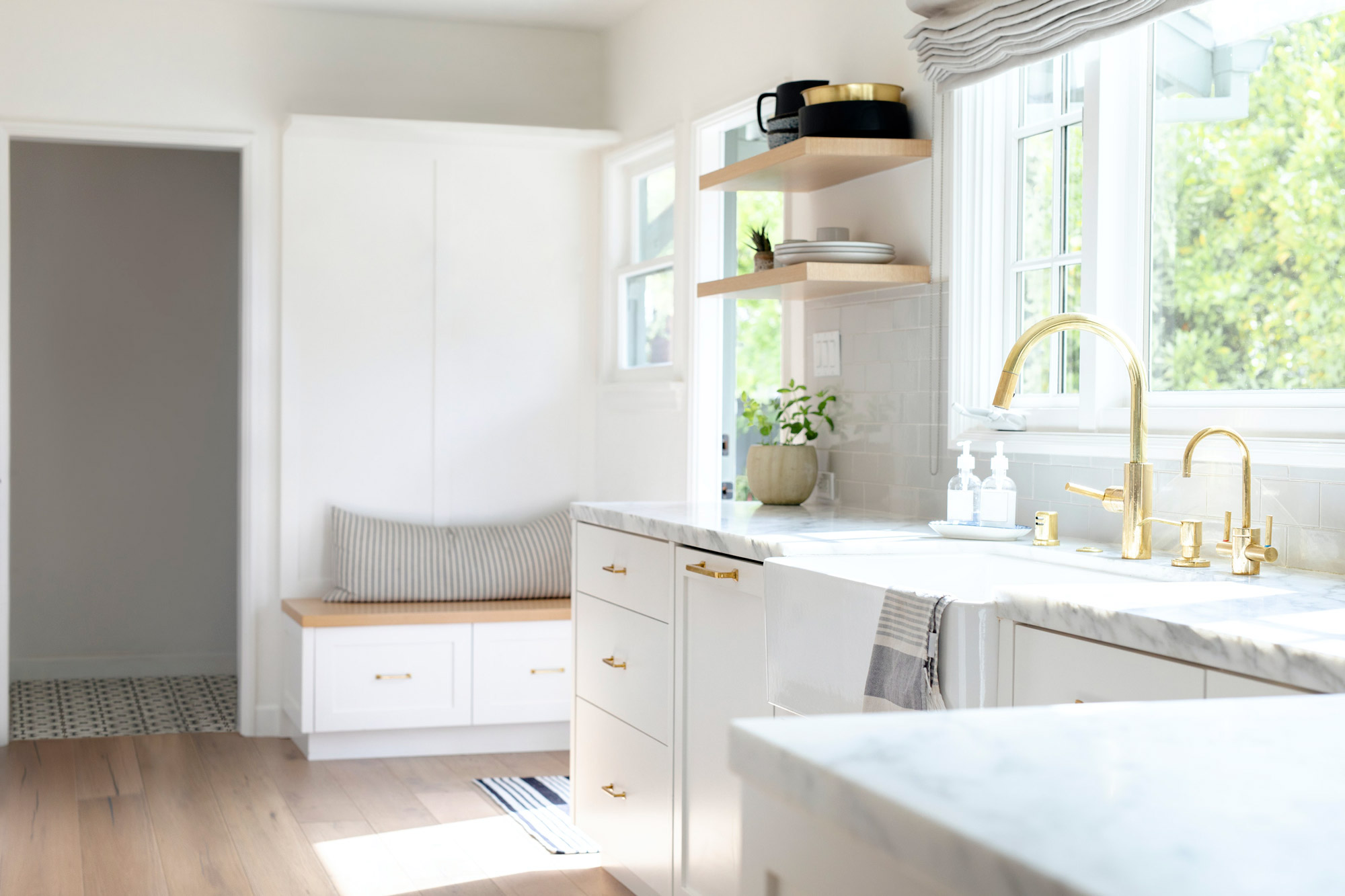 Kitchen adorned with marble tops and brass furnishings