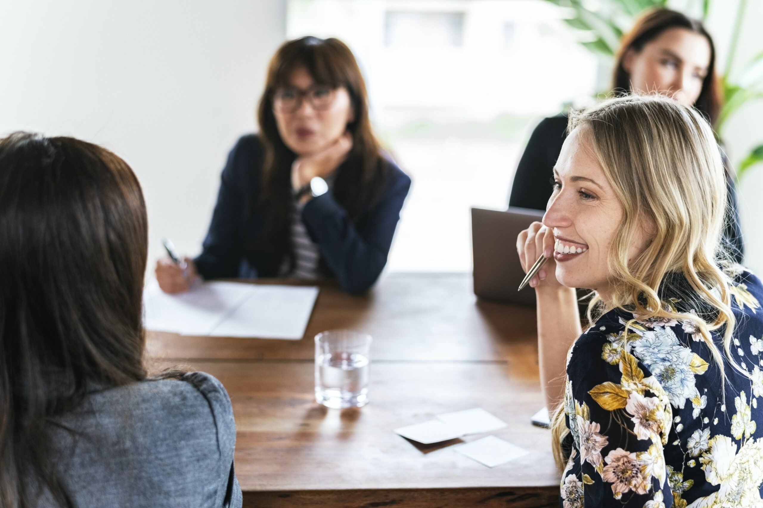 Four people gathered at a table for a business meeting