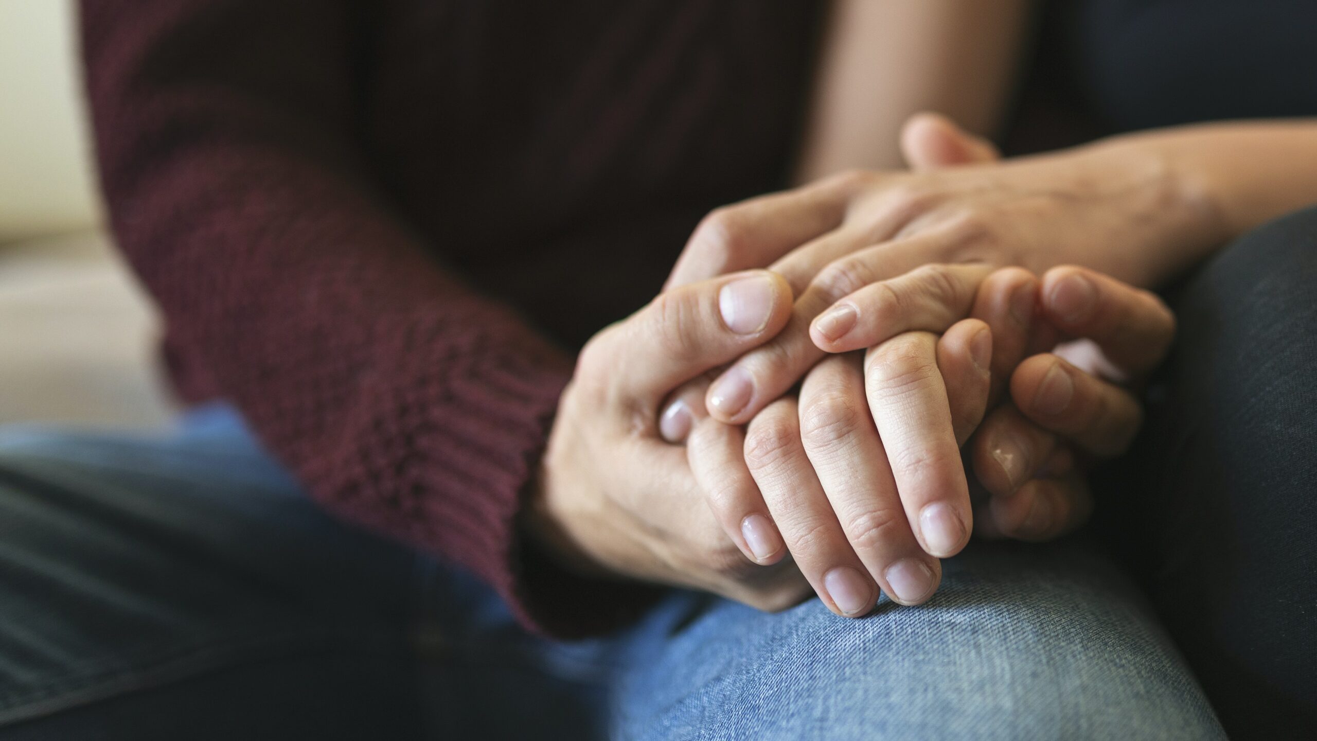 Close up shot of couple holding hands