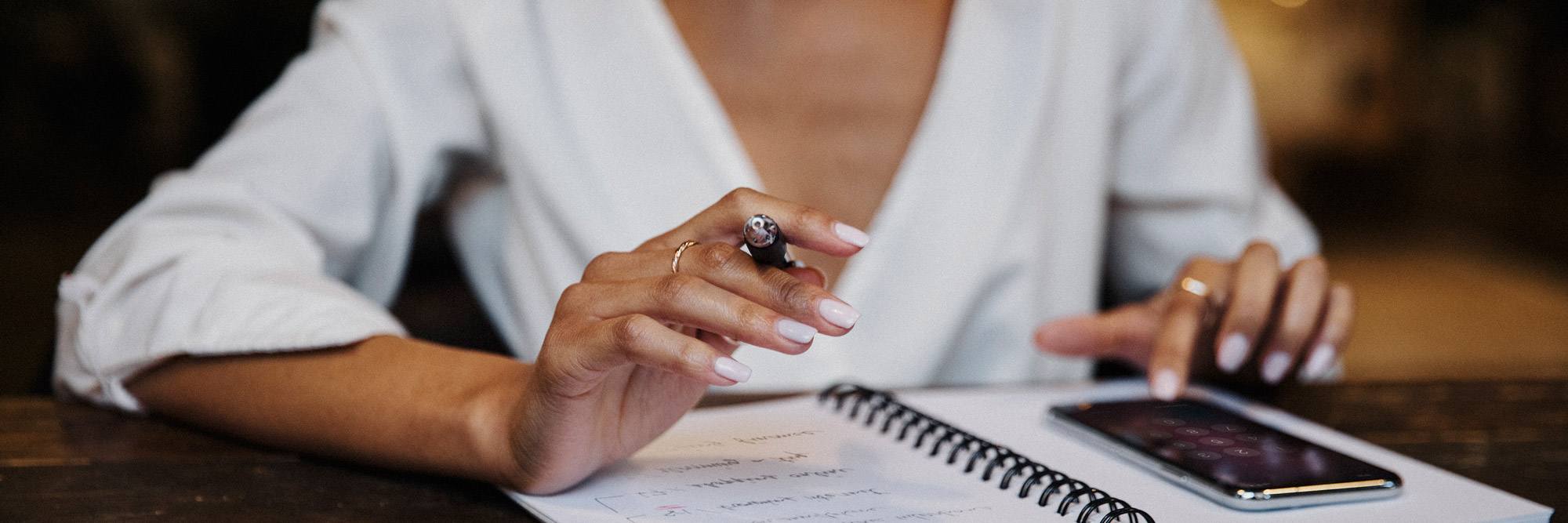 Close up shot of lady's hands while writing