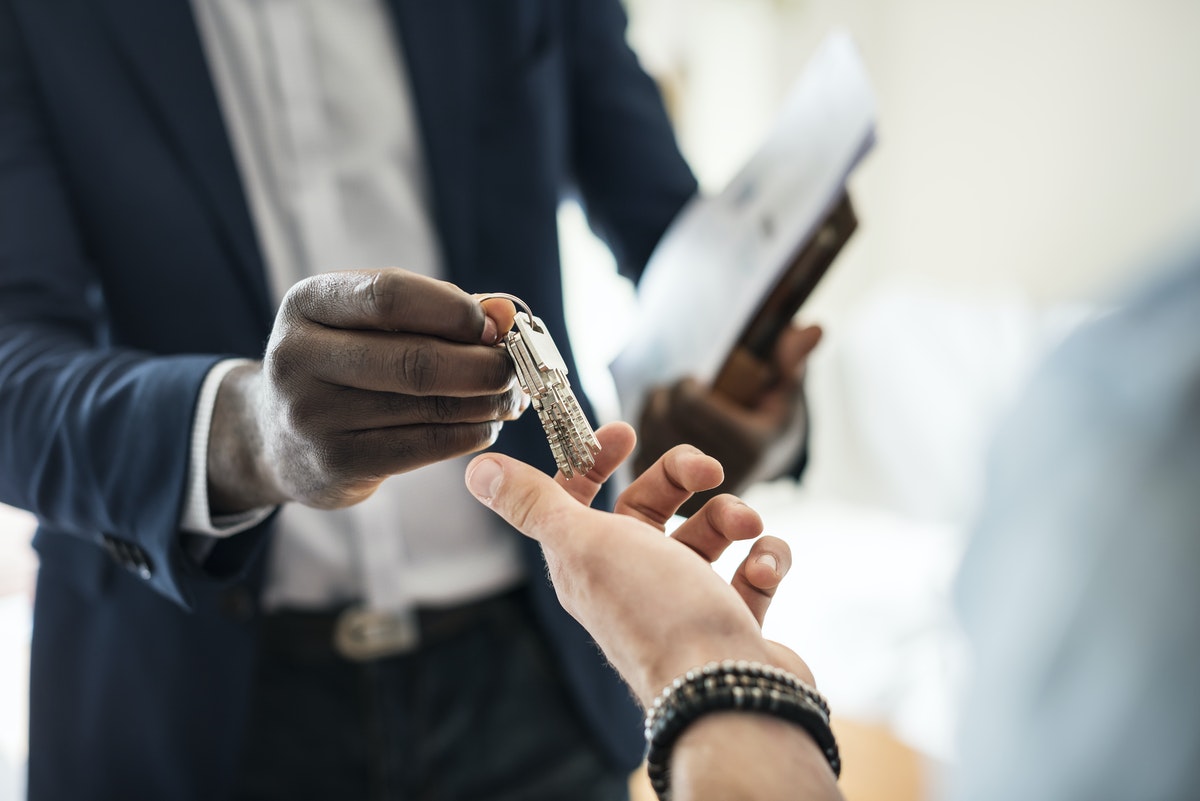 Person handing keys to another person