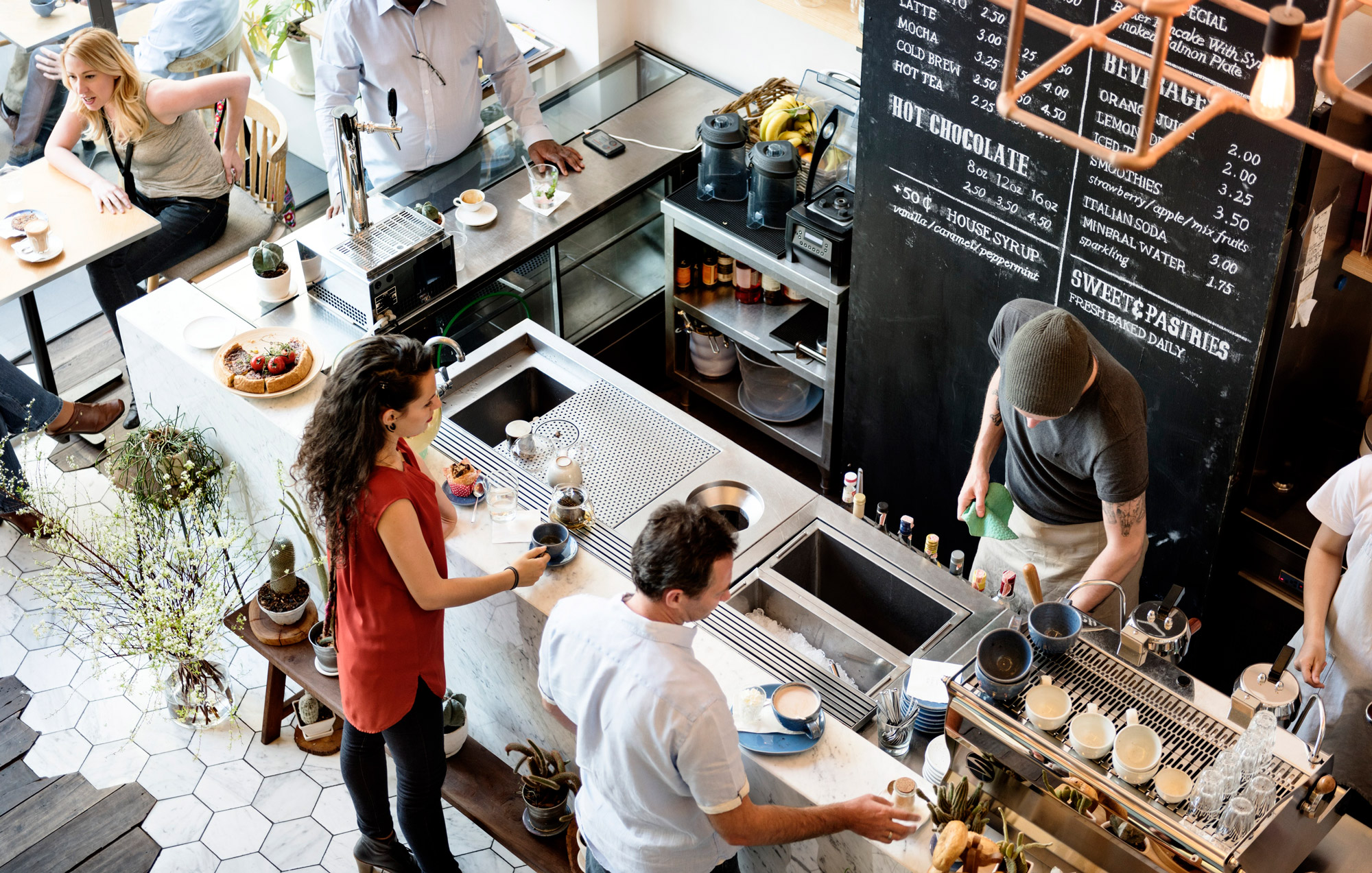 Overhead image of customers ordering drinks at a coffee bar