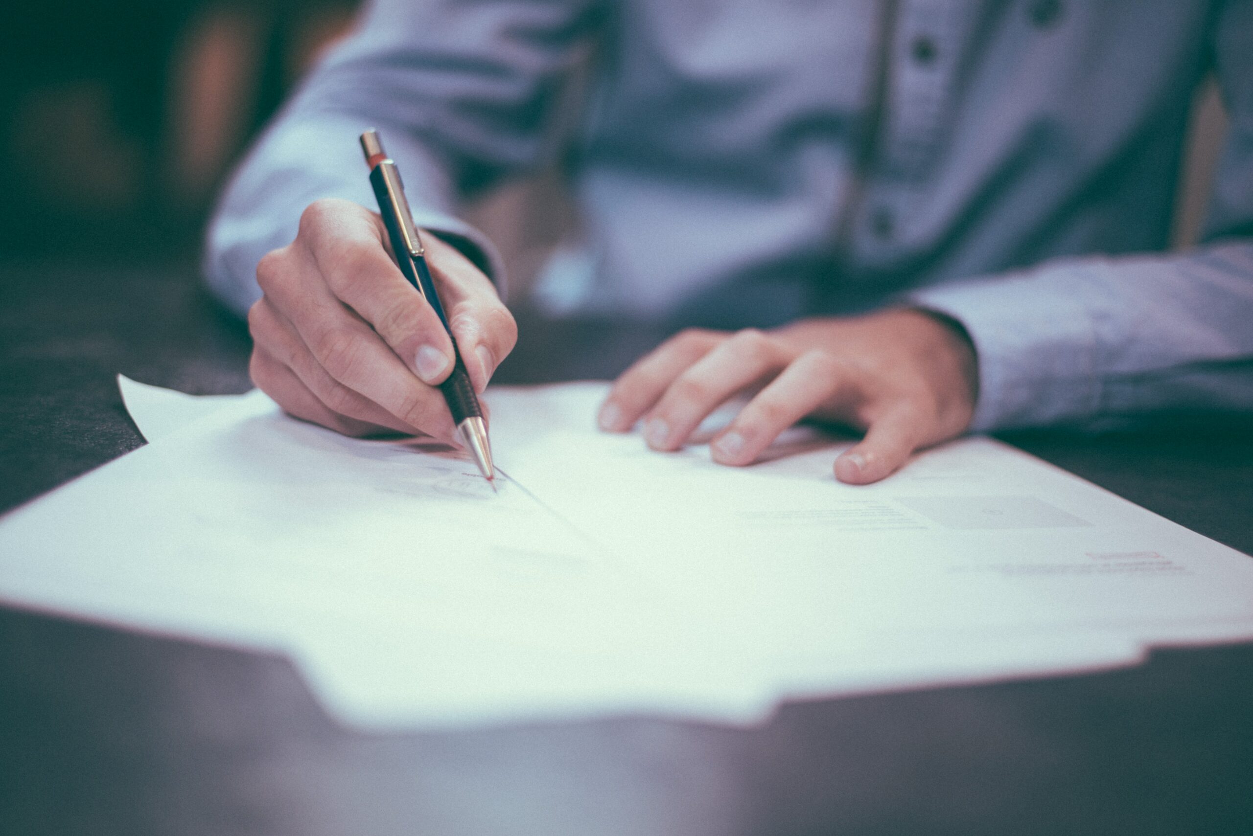 man signing a document